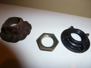 The old washer and nut versus the new plastic nut
